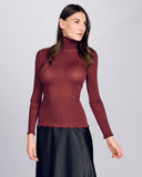 Aromatique's burgundy accordion ribbed wool turtleneck is seamless through the body with a back seam on the turtleneck itself