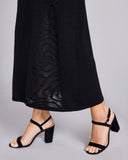 Knit-in floral “lace” detailing at the front left adds visual interest to Arya Cashmere's black maxi skirt