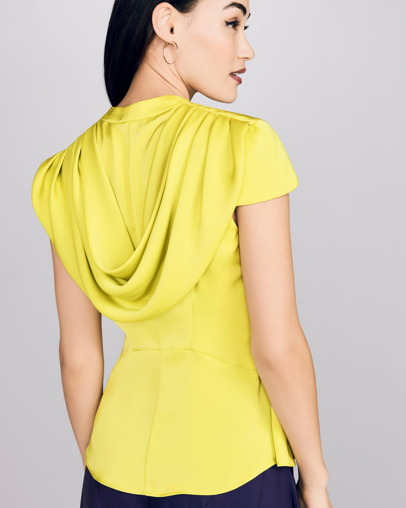 Blouse from D2Line showcases delicate cap sleeves and a draped cowl cape at the back&nbsp;