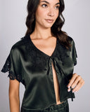 The Emma Harris Clara Moss Bed Jacket is crafted from deep moss green silk with black shimmering floral lace appliqué