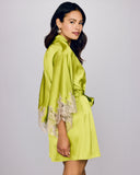 The Rochelle Lime silk kimono robe has a shawl collar and matching silk belt with lace appliqué at the ends