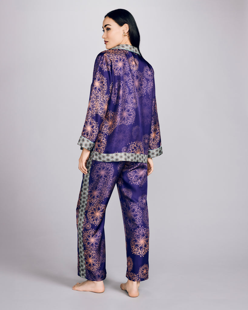 The Isa Hanabi Violine pant from Karma on the Rocks has a loose fit with a fully elasticized waist, pockets, and contrast print down the sides of the legs