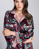 Exquisite Kazari Aqua silk pajama from Karma On The Rocks is crafted from a luxurious burgundy red silk charmeuse with a gingko print in shades of teal and contrast red and silver geometric print