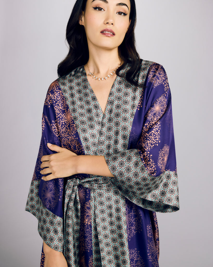 The Kobe Hanabi Violine silk robe from Karma on the Rocks is crafted from a decadent purple silk twill with a rose gold print and geometric turquoise silk print accents