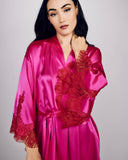 Classic Arielle short robe from Layalina is crafted from neon pink silk with lavish red lace appliqué at the sleeves