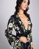 Vintage-inspired Aphrodite robe from Temperley is crafted from black silk with a pattern of monkeys, parasols, leopards, pagodas, and flowers in shades of green and white 