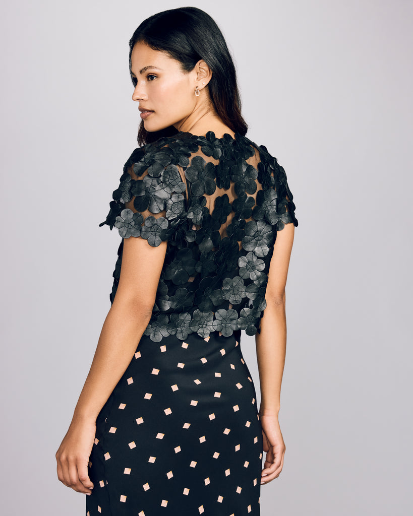 Daisy shrug from Zambak showcases soft black leather flowers individually stitched to sheer black tulle