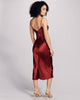 Curve hugging Sophia midi slip dress from Gilda & Pearl is crafted from a vibrant ruby red silk