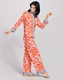 Karma on the Rocks Tokyo Aka cotton pajama is crafted from a lightweight cotton with an orange and white floral print and contrasting purple, orange and blue chevron print
