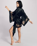 The Aamiya robe from Merle Noir hits at mid thigh on most, with traditional vented kimono sleeves and an ultra-long black silk sash