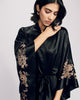 Exquisite Aamiya black silk robe from Merle Noir is embellished with shimmering Leaver’s lace appliqué in shades of rose gold and gold