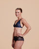 Non-underwired bra is constructed of intricately-styled black and blue mesh and lace from Lise Charmel